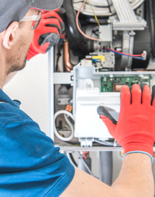 Innovative Mechanical Solution's worker repairing an AC in a Boise ID Home